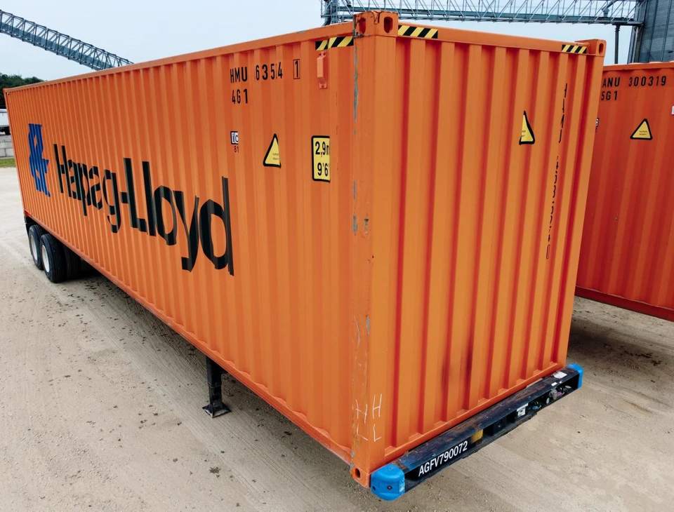 Orange shipping container on a chassis